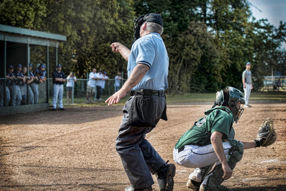 Umpire in youth baseball game making a call.