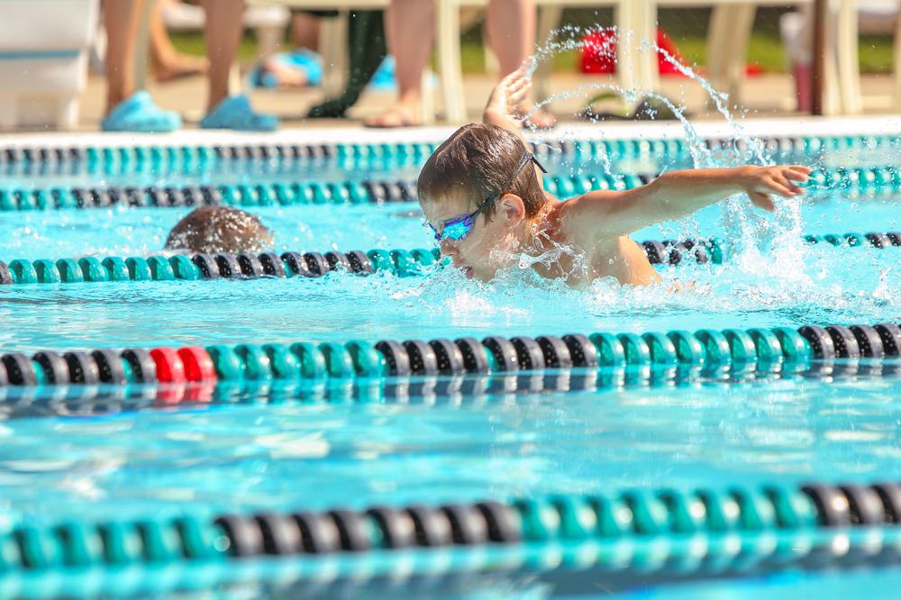 Young boy competing in a swim competition.
