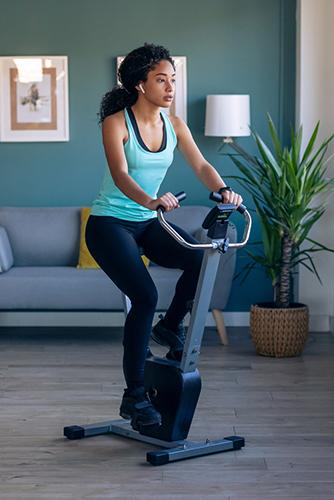 Young woman on stationary bike.