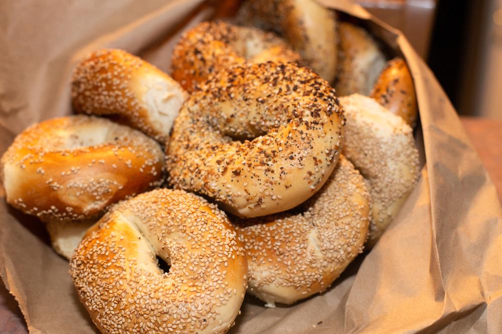 Brown bag full of bagels.