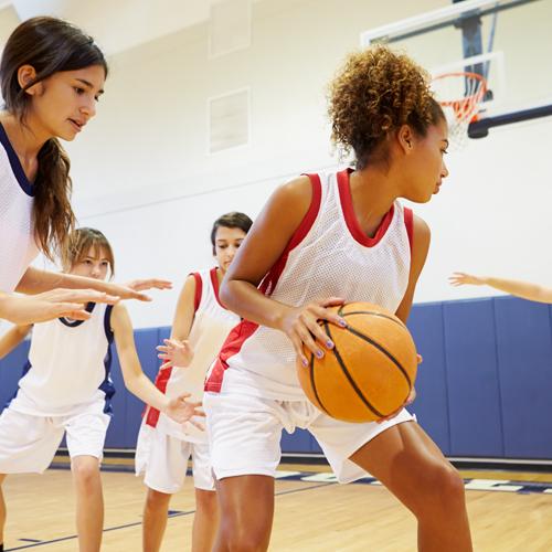 Young female basketball players during a scrimmage.