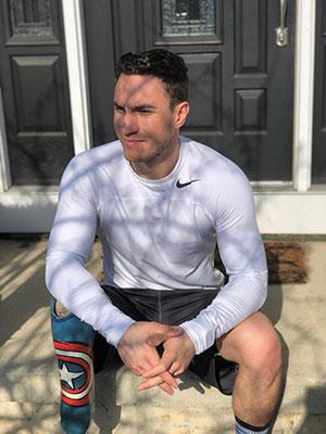 Paralympian Tyler Carter sitting on a stoop