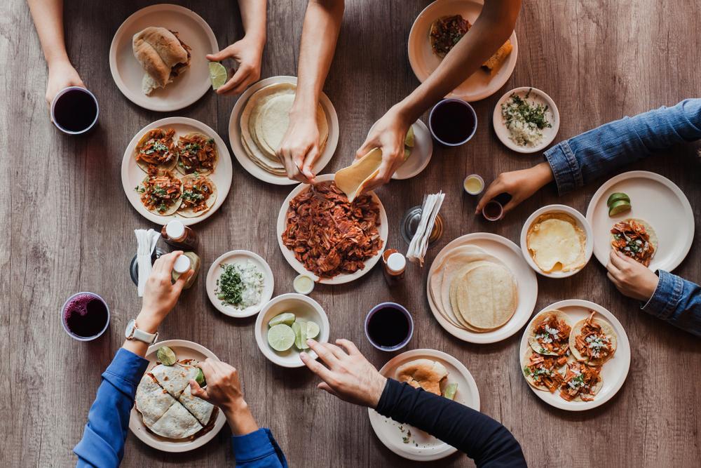 Family making byo-tacos at dinner table.