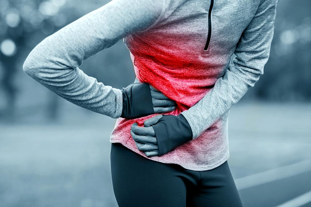 Close up of a woman getting a side cramp with a red color added to her side.