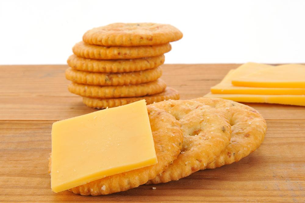 Cheese slices and crackers closeup.