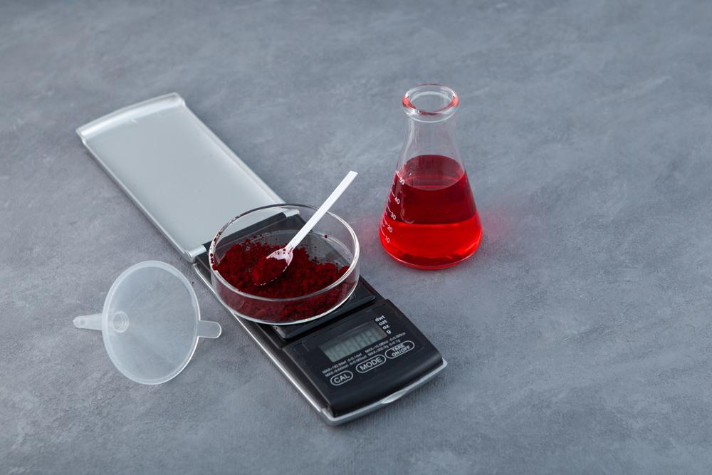 Red artificial food dye in powder and liquid form.