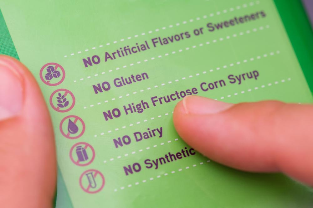 Finger pointing at a food label that reads, "No High Fructose Corn Syrup"