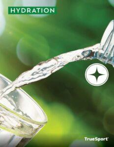 pouring water into a glass on a green blurred background