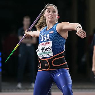 Kara Winger about to throw a javelin.