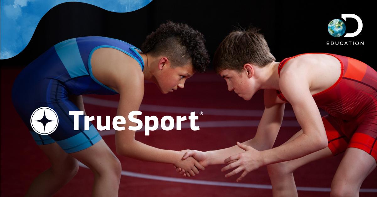 two young boys wrestling and shaking hands