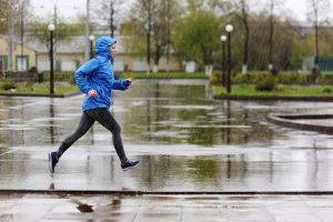 coping with quarantine Woman running in rain.