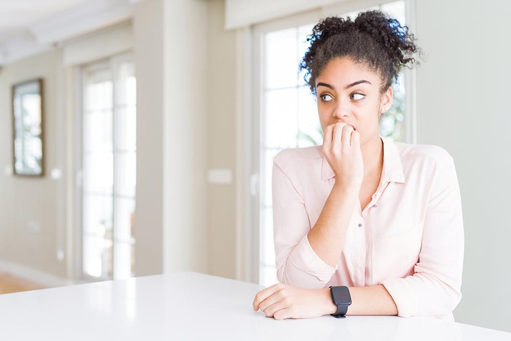 Anxious mom alone in home.