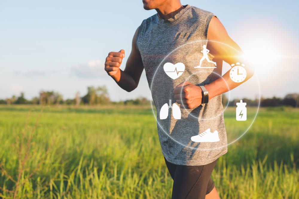 Man running with smart watch with graphics indicating what it's tracking.