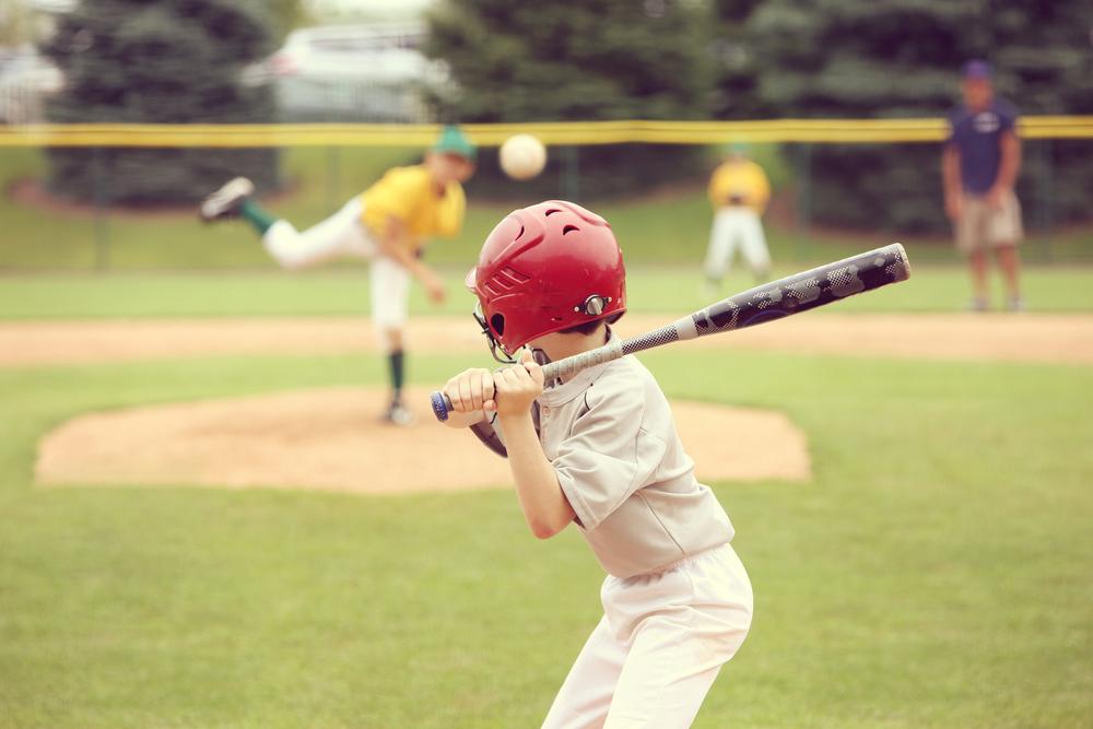 Young boy at bat during baseball game.