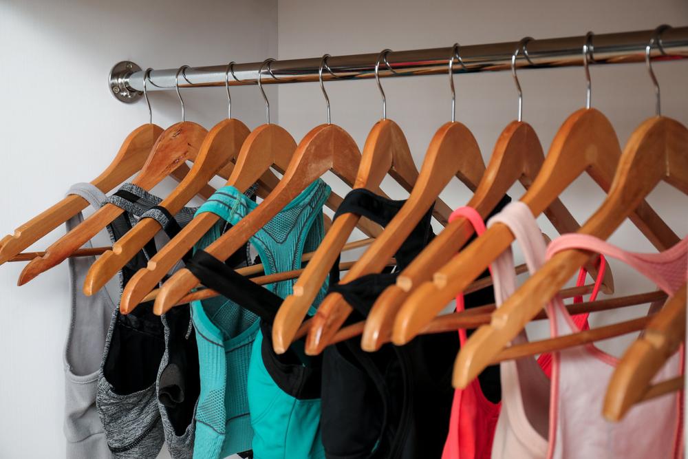 Hangers on a rack all holding sports bras.