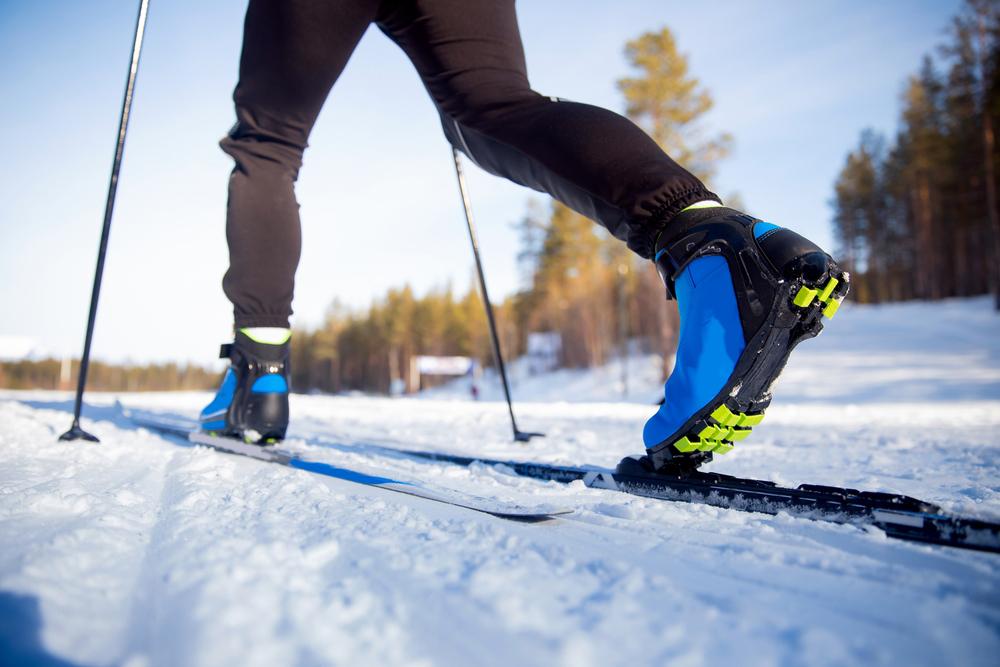 Close up of legs of cross country skiier on snow.