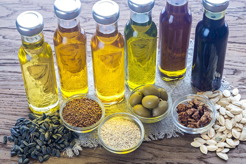 A variety of different cooking oils in glass.