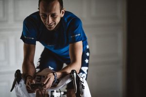 Aaron Schedies training on a bicycle.