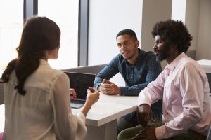 Teacher and parent and child in a conference.