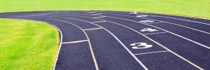 black running lanes with green grass on the sides