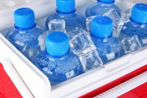 Water bottles in an ice filled cooler.