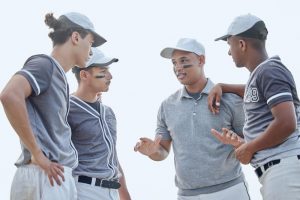 Coach talking to a baseball team.