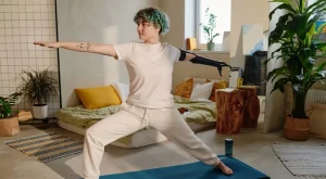 Young woman with arm aputation doing yoga.