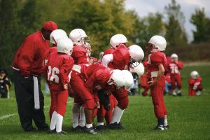 Peewee football team with coach.