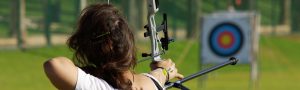 girl shooting arrow at target