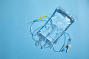 An IV infusion bag against a blue background.