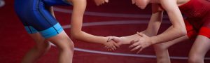 Two young wrestlers shaking hands before a meet.