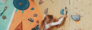 Girl indoor rock climbing.