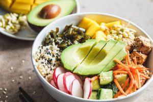 Tofu bowl with rice, veggies, and avocado.