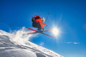 Free skiier doing a jump on a mountain.