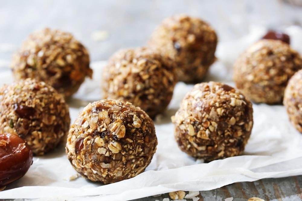 Chilled energy balls resting on parchment paper.