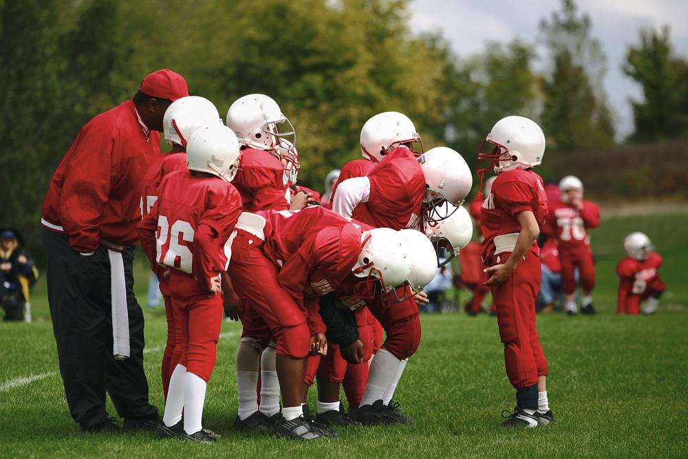 Peewee football team with coach.