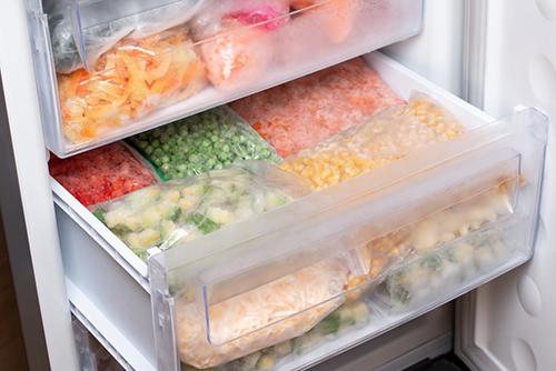 Frozen foods in bags in a freezer.