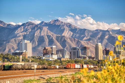 A city in front of rocky mountains.