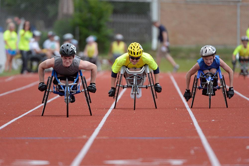 Three handcyclists in a race.