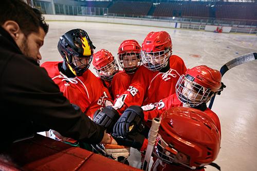 Young hockey team with coach on ice.