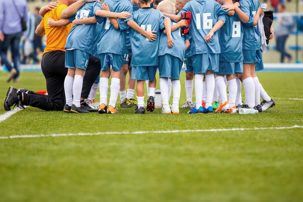 Youth soccer team in a huddle.