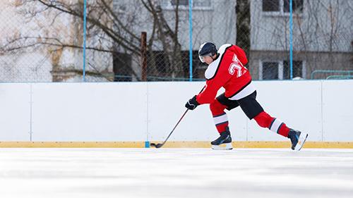 Male hockey player on ice.