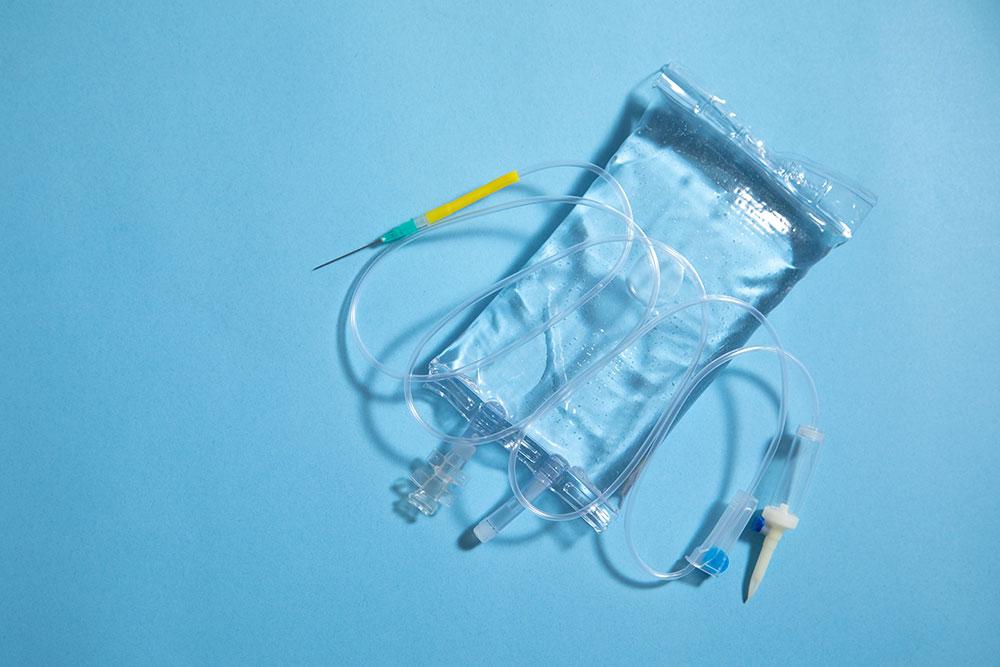 An IV infusion bag against a blue background.