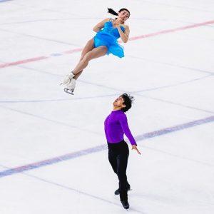 Luke Wang and Olivia Flores pairs figure skating on the ice.
