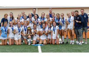 Coach Powell Paguibitan posing with his state championship girls soccer team.