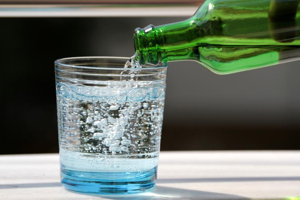 Seltzer water being poured into a glass.