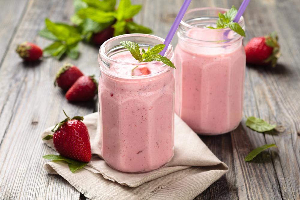 Strawberry smoothies in glass jars.