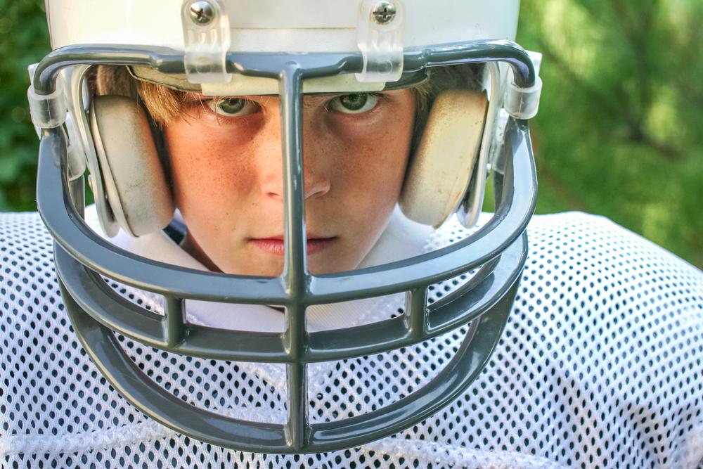 Close up image of a young boy football player.