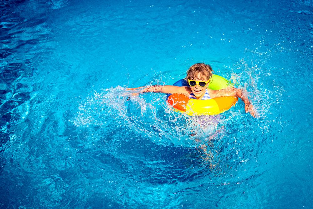 Young child in pool on vacation.