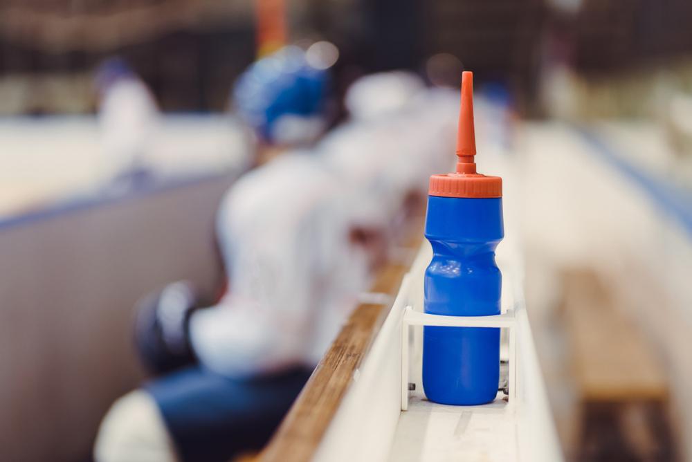 Water bottle on a hockey bench.